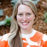 a professional headshot of Carissa Bartek smiling with plants in the background.