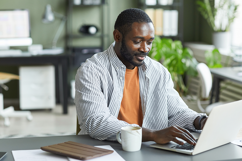 Man at desk working on laptop